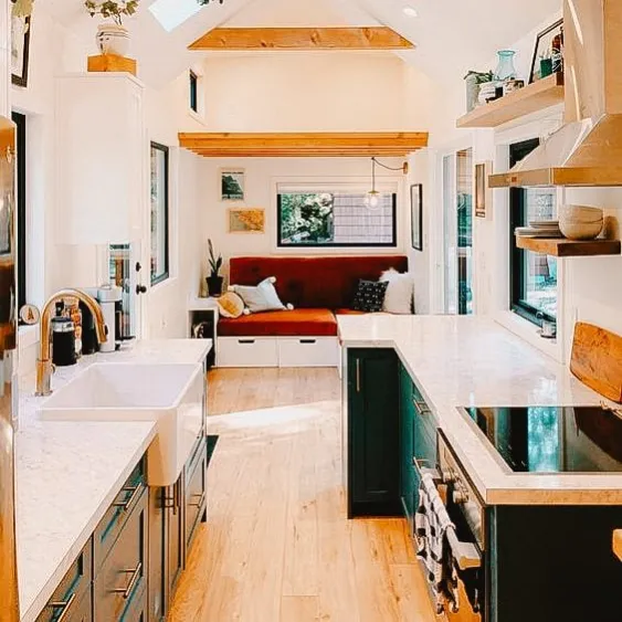 Modern tiny home interior with a bright kitchen and cozy living area