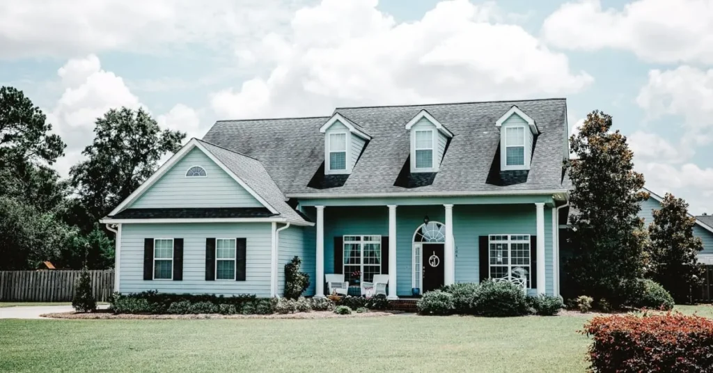 Beautiful suburban home with a large front yard, featuring classic architecture and a welcoming porch.