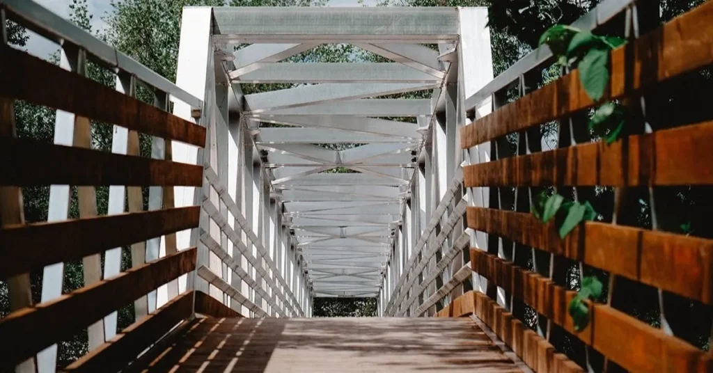 Wooden boardwalk supported by eco-friendly screw piles.