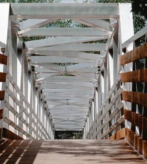 Wooden boardwalk supported by eco-friendly screw piles.