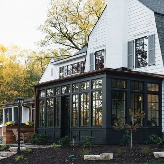 Charming sunroom extension with large windows, seamlessly blending into the home’s architectural design, creating a peaceful and cozy retreat.