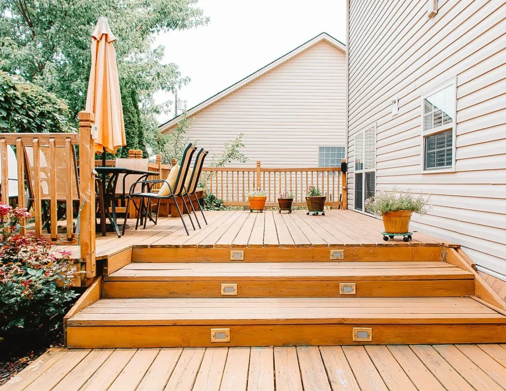 Wooden backyard deck with outdoor seating and plants