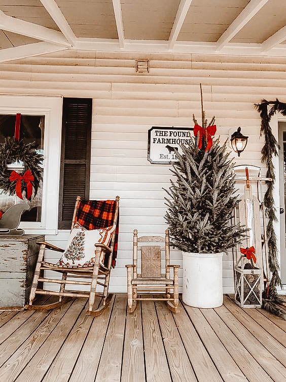 You can see a front porch decorated in a farmhouse look.