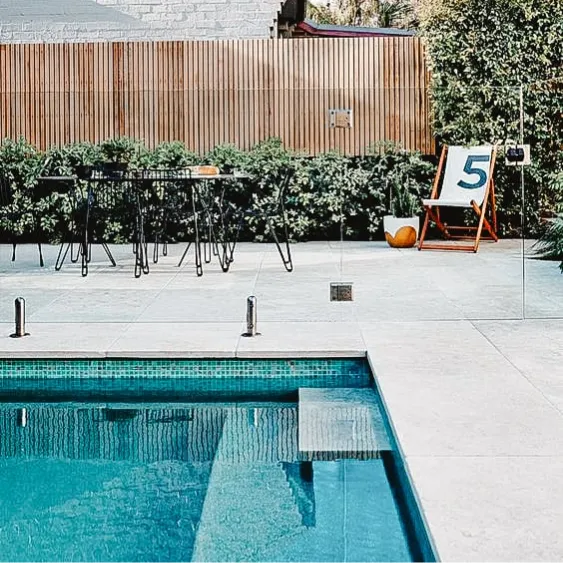 Modern poolside terrace with a minimalist design and outdoor seating area