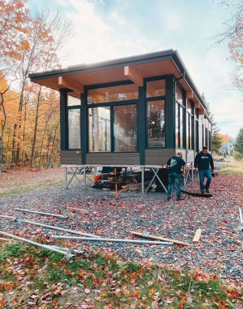 Modern forest cabin under construction on screw piles