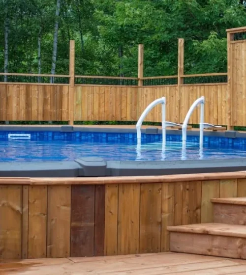 Elevated above-ground pool deck surrounded by wooden fencing, demonstrating the structural support offered by screw piles.