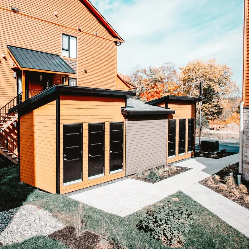 Two modern sheds with sturdy foundations, supported by screw piles, providing long-lasting stability for garden structures.