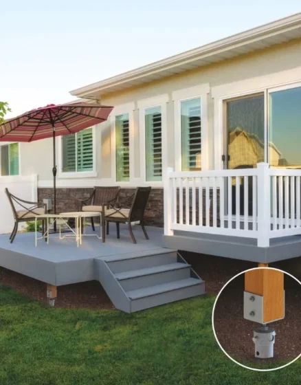 Modern backyard deck with outdoor seating and an umbrella, supported by screw pile foundations for durability and stability.