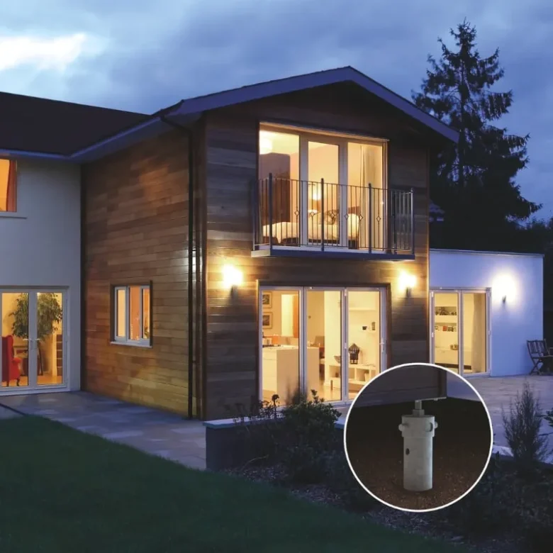 Modern home with an illuminated two-story addition, supported by screw pile foundations for strength and stability.